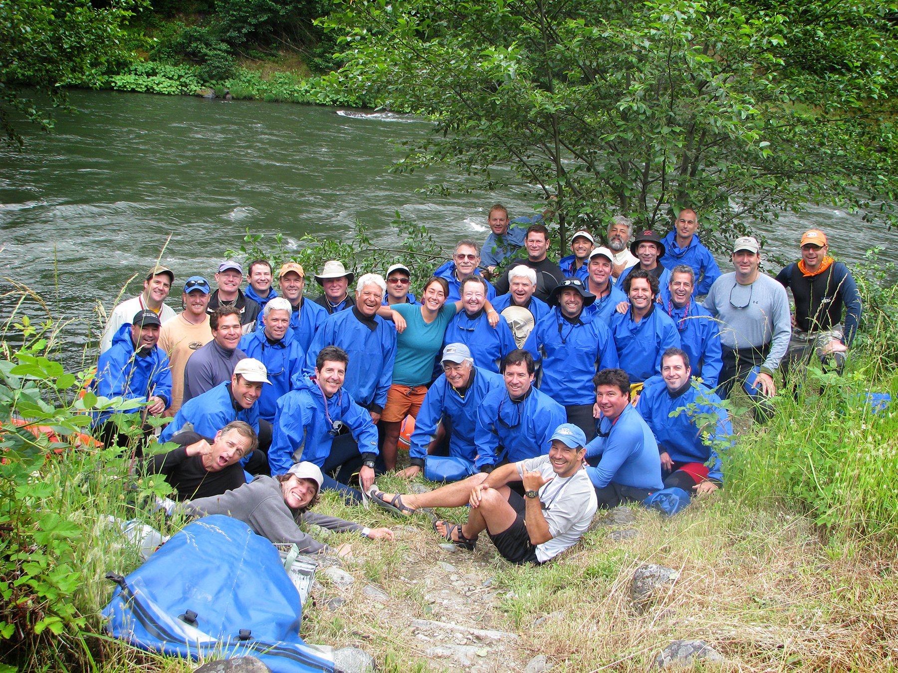 Large corporate group gathers for photo on whitewater rafting trip