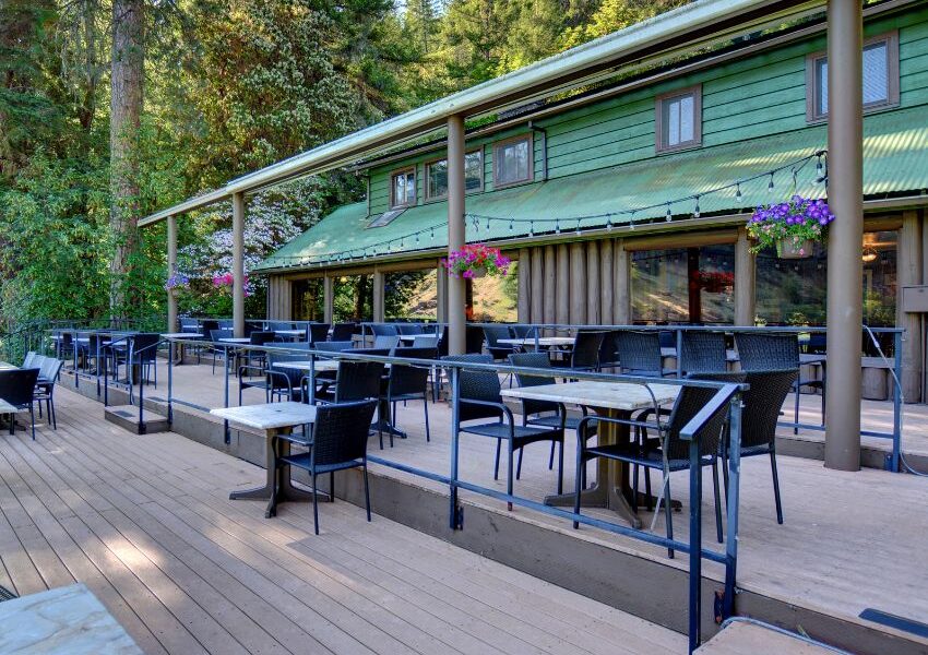a green lodge building located on the Rogue River in southern Oregon