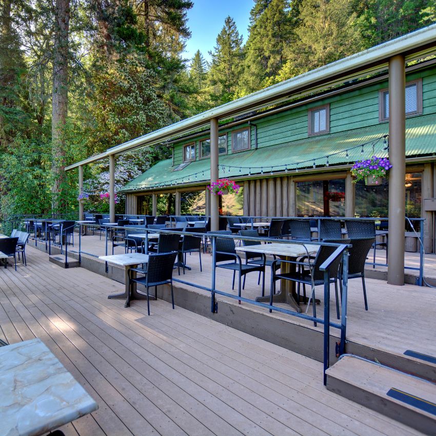 a green lodge building located on the Rogue River in southern Oregon