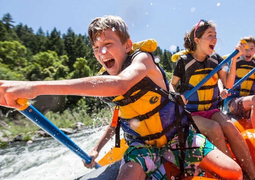 kid smiles while rafting on the Rogue River in Oregon