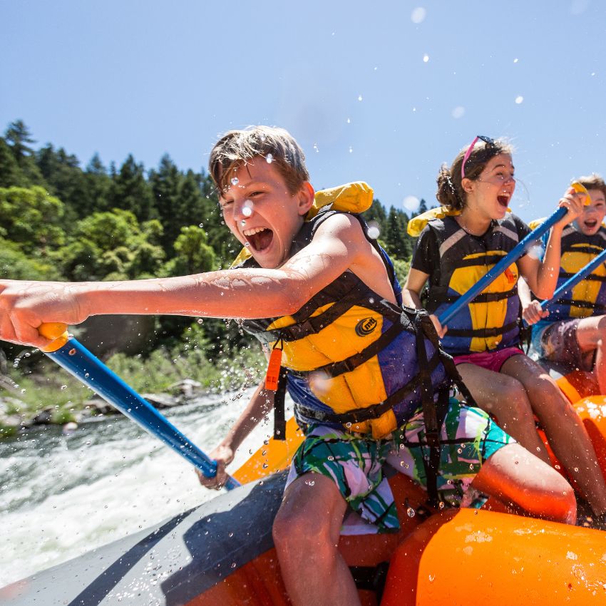 kid smiles while rafting on the Rogue River in Oregon