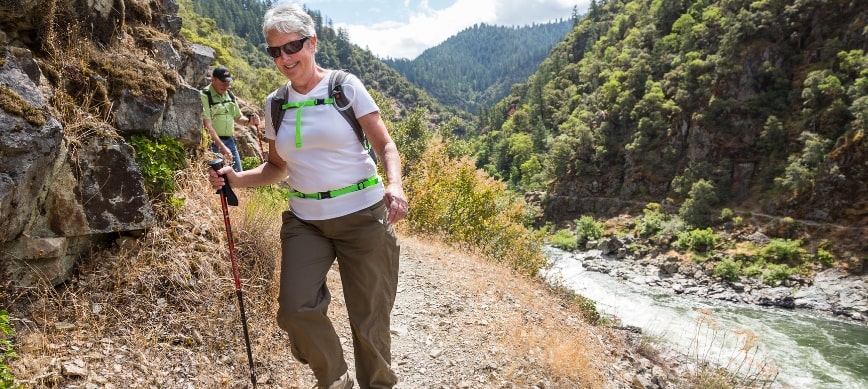 hiking the rogue river trail a woman hikes along a winding river in a canyon
