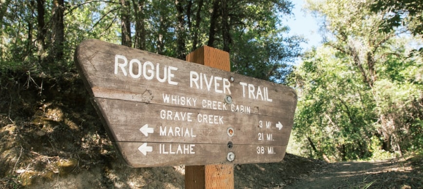 rogue river hiking a brown sign that reads "Rogue River Trail"