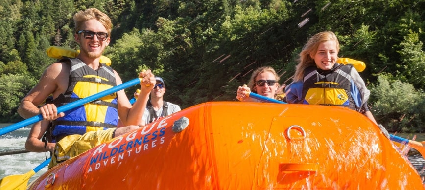 rogue river oregon camping rafting trip rafters paddle on a raft on the rogue river