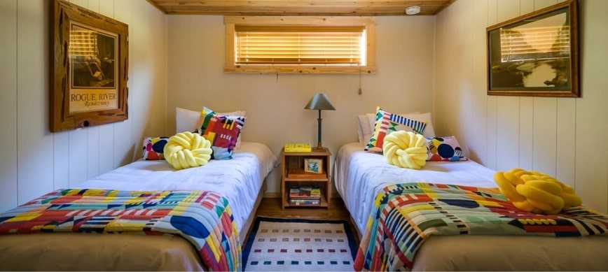 rogue river rafting half moon bar lodge trip two single beds next to each other in a white rustic room